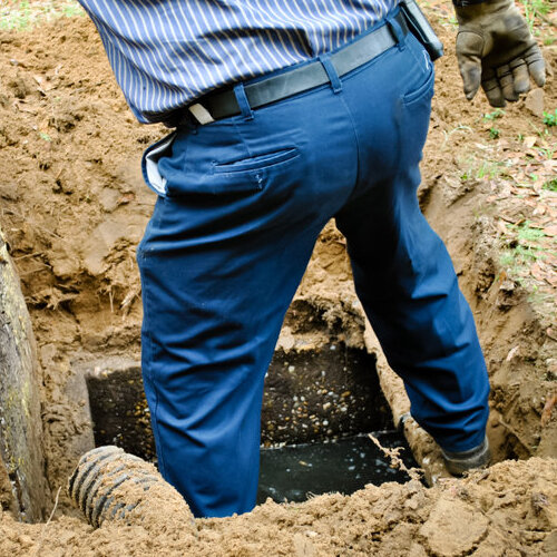 worker opening a septic tank