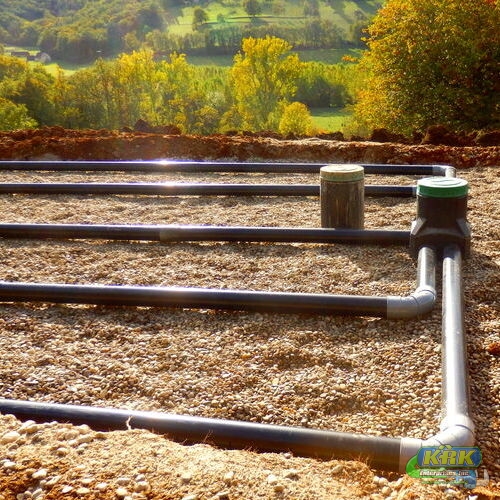 the top layer of pipework, after the membrane, sand and gravel had been applied, during the construction of a sand and gravel drainage system