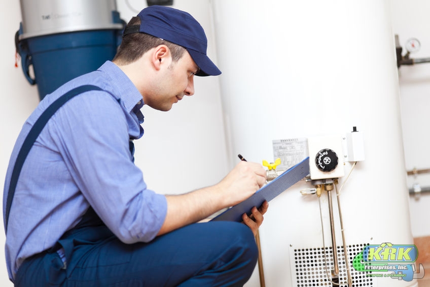 A Picture of a Man Writing On a Clipboard About a Water Heater Repair.