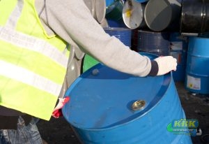 Man moves a recycling drum