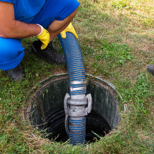 This Plumber is Removing Waste from a Septic Tank